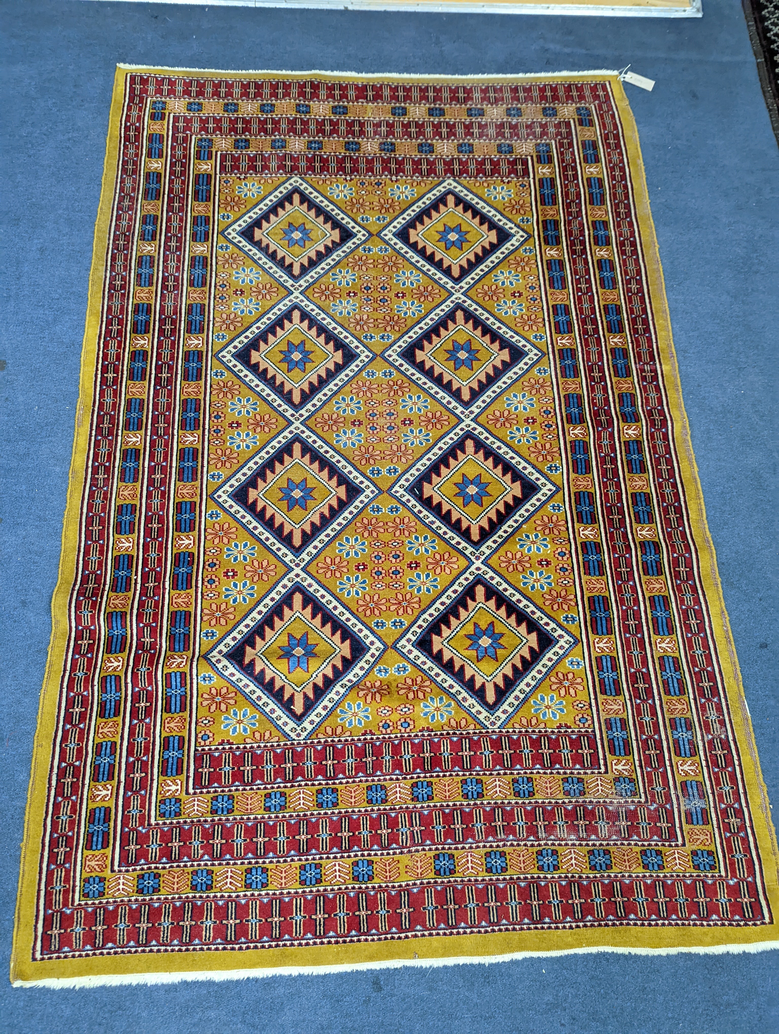 A Caucasian style gold ground rug, 190 x 124cm